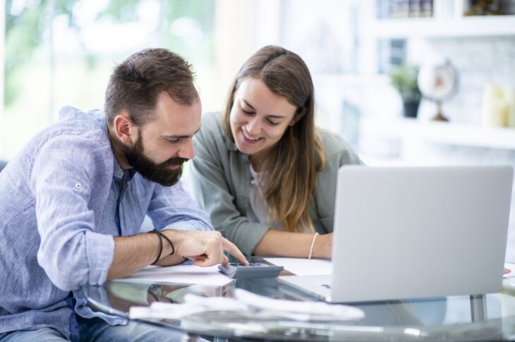Couple reviewing passive income strategies using investment statements