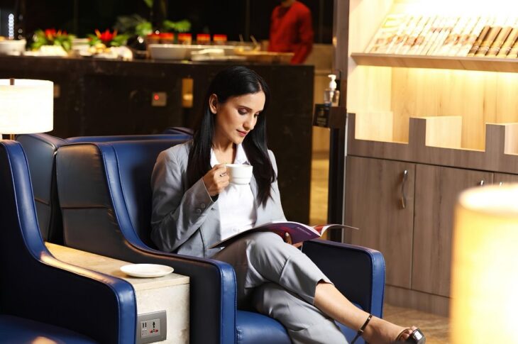 Traveler considering the value of frequent flyer points in an airport lounge