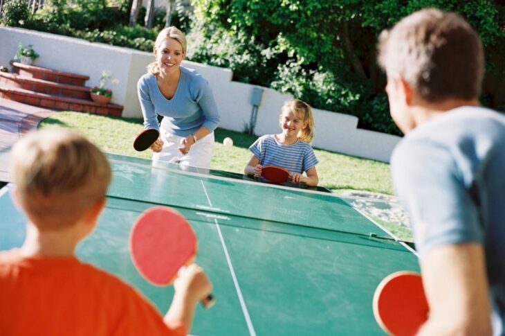Family playing an outdoor ping pong